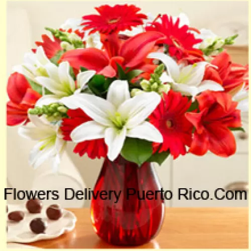 Red Gerberas, White Lilies, Red Lilies And Other Assorted Flowers Arranged Beautifully In A Glass Vase
