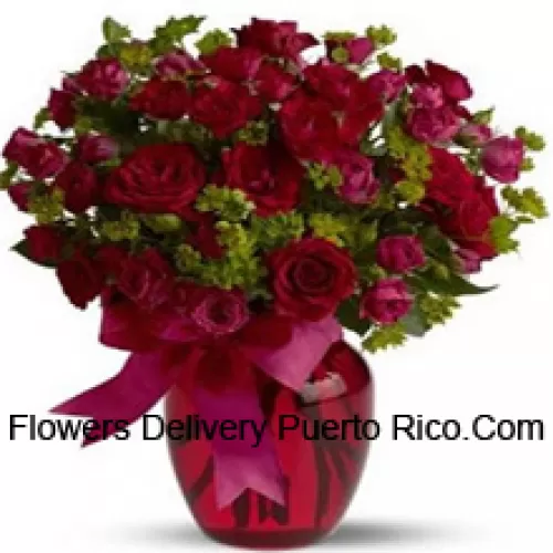 26 Red And 25 Pink Roses With Some Ferns In A Glass Vase