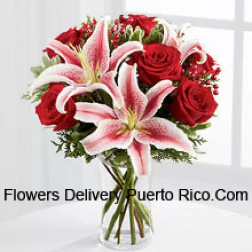 This Bouquet?is a simply stunning display of seasonal glamour they won't be able to resist. Rich red roses are paired with the dazzling beauty of Stargazer lilies accented with holiday greens, berry sprays and a bordeaux satin rbbon for an elegant look. Arranged in a clear glass vase, this bouquet will add to the magic and wonder of their holiday festivities. (Please Note That We Reserve The Right To Substitute Any Product With A Suitable Product Of Equal Value In Case Of Non-Availability Of A Certain Product)