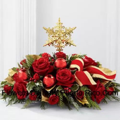 A grand and elegant way to add to the beauty of their holiday festivities. Rich red roses and spray roses are arranged with assorted holiday greens, variegated holly, shiny red holiday balls and a gold-edged red ribbon, all encircling a gold metallic star-shaped tree topper to create a unique and sophisticated holiday centerpiece.? (Please Note That We Reserve The Right To Substitute Any Product With A Suitable Product Of Equal Value In Case Of Non-Availability Of A Certain Product)